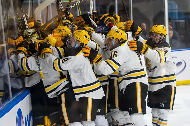 AIC players celebrate an overtime win over Robert Morris in the Atlantic Hockey semifinals (2019 Omar Phillips)