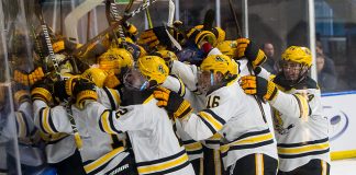 AIC players celebrate an overtime win over Robert Morris in the Atlantic Hockey semifinals (2019 Omar Phillips)
