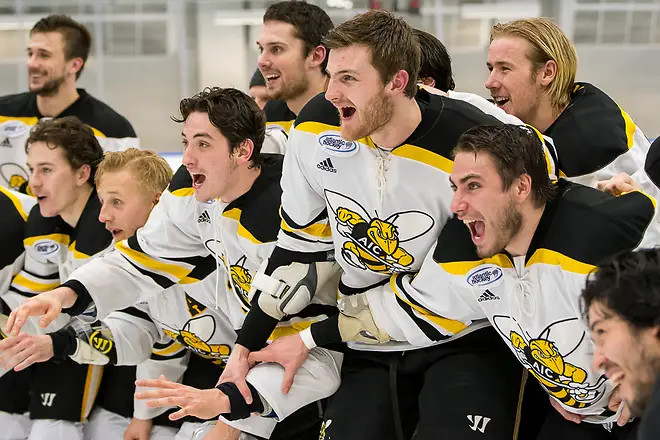 AIC players await the Atlantic Hockey championship trophy (2019 Omar Phillips)