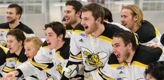 AIC players await the Atlantic Hockey championship trophy (2019 Omar Phillips)